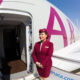 qatar_airways_flight_attendant_welcoming_passengers_on_board_an_airbus_a380-1.jpg