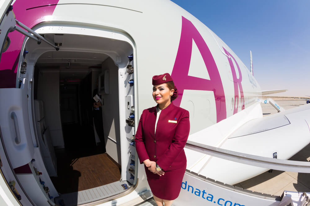 qatar_airways_flight_attendant_welcoming_passengers_on_board_an_airbus_a380-1.jpg