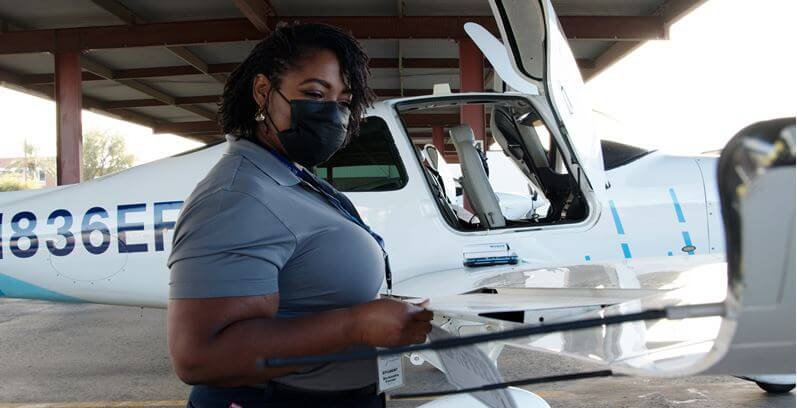 United Aviate cadet Ricki by a training aircraft