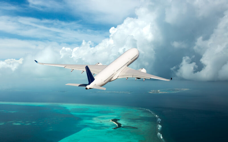 A,Passenger,Plane,In,The,Cloudy,Sky.,Aircraft,Flies,Over