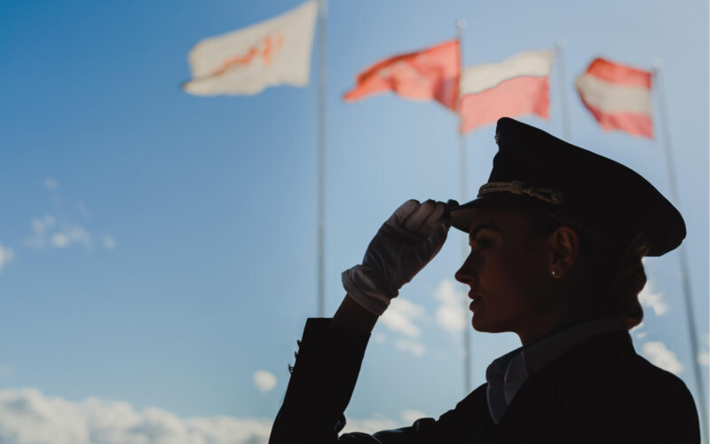 silhouette_of_a_female_pilot_with_flags_in_the_background.jpg