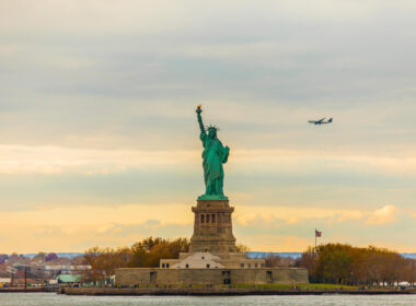 statue_of_liberty_seen_with_a_plane_in_the_background.jpg