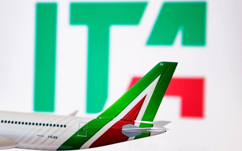 the_ita_logo_is_seen_against_an_alitalia_plane_model.jpg