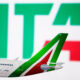 the_ita_logo_is_seen_against_an_alitalia_plane_model.jpg