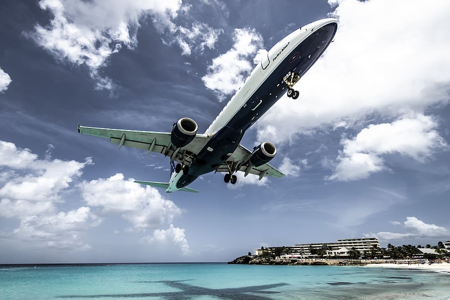 white-aircraft-above-beach-shoreline-at-daytime.jpg