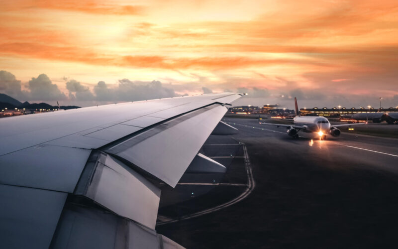 wing_of_an_airplane_taking_off_on_runway.jpg